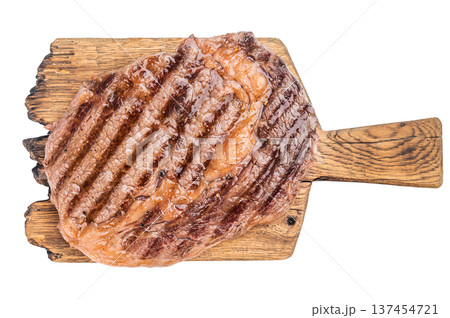 Grilled ribeye beef steak with seared crust and juicy marbled texture on wooden board with herbs. Cooked premium meat with copy space. Grilled ribeye beef steak with seared crust and juicy marbled texture on wooden board with herbs. Cooked premium meat with copy space. 137454721