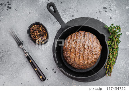 Grilled beef lamb burger patty cooked to perfection with crispy crust and moist center. Gourmet meat cutlet in skillet on stone. 137454722