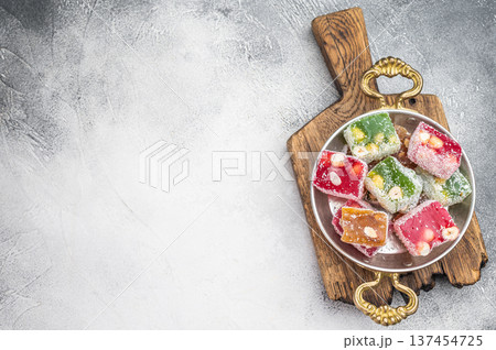 Turkish delight candy cubes in mixed colors. Gourmet jelly dessert with hazelnut and coconut top view. 137454725