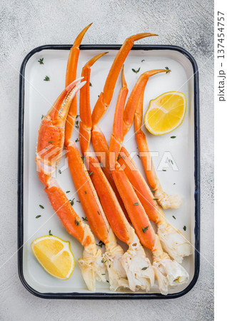 Gourmet kamchatkan red crab legs with lemon and thyme arranged on white tray high quality seafood overhead shot Gourmet kamchatkan red crab legs with lemon and thyme arranged on white tray high quality seafood overhead shot 137454757