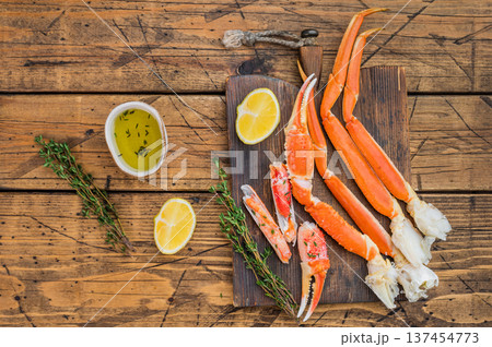 Luxury king kamchatka crab cooked seafood served with lemon and herbs on rustic wooden board premium gourmet copy space 137454773