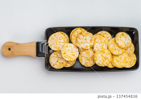 Packaged rice crackers in food container. Overhead view with copyspace for branding. Packaged rice crackers in food container. Overhead view with copyspace for branding. 137454816
