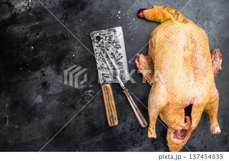 Raw GameBird Muscovy duck with plucked skin on black background. Wild game poultry ingredient for roasting traditional recipes.. Raw GameBird Muscovy duck with plucked skin on black background. Wild game poultry ingredient for roasting traditional recipes.. 137454833
