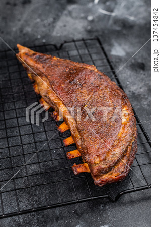 Grilled lamb breast ribs with crispy crust on dark stone background barbecue meat with copy space 137454842