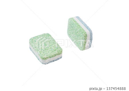 Green and white dishwashing tablets on clean white backdrop symbolizing hygiene household cleaning and modern kitchen care 137454888