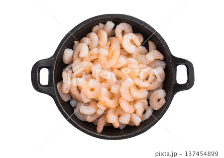 Small peeled shrimp in cast iron pan on isolated background , seafood ingredient background with copy space for recipes and menu design. 137454899