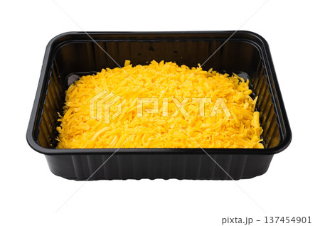 Grated cheddar cheese in plastic bowl on white backdrop bright yellow dairy product for pizza pasta nachos and comfort food 137454901