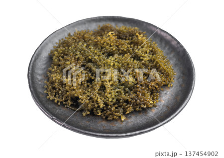 Fresh sea grapes also known as green caviar and sea caviar served in bowl on isolated background exotic Japanese umibudo seaweed 137454902