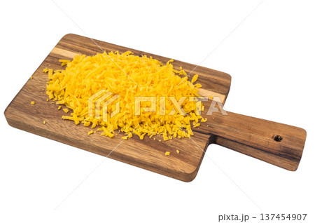 Grated cheese pile and kitchen grater on rustic board isolated backdrop food preparation concept with copy space Grated cheese pile and kitchen grater on rustic board isolated backdrop food preparation concept with copy space 137454907
