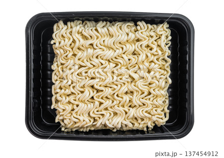 Raw dehydrated ramen noodles in square block form on clean white studio background minimal food ingredient texture detail Raw dehydrated ramen noodles in square block form on clean white studio background minimal food ingredient texture detail 137454912