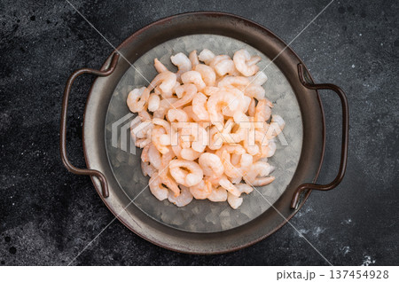 Small prawns in vintage pan on black background, seafood cooking ingredient with copy space for restaurant and food branding. 137454928