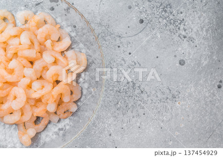 Mini peeled prawns portion, frozen salad shrimp in transparent plate, clean protein seafood ingredient for diet and catering concept. 137454929