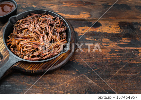 Shredded smoked beef brisket, low and slow barbecue meat in skillet, hearty protein rich homemade dinner concept. 137454957