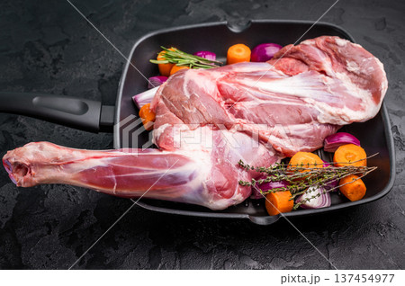 High quality raw lamb shoulder leg, an essential ingredient for hearty stews and savory dishes. black background. top view 137454977