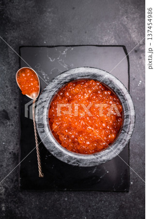 Exquisite salmon roe, vibrant and rich, ideal for adding a touch of elegance to your culinary creations. black background. top view 137454986