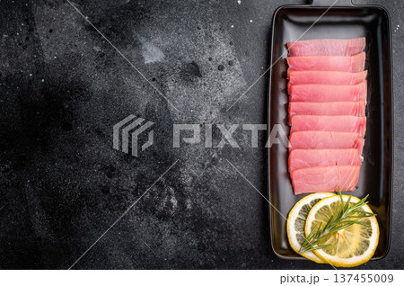 Premium quality tuna sashimi, expertly cut for maximum tenderness and taste, perfect for sushi enthusiasts. black background. top view 137455009