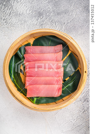Artful presentation of fresh tuna sashimi, a deliciously healthy choice that delights the senses and pleases the palate. white background. top view 137455012