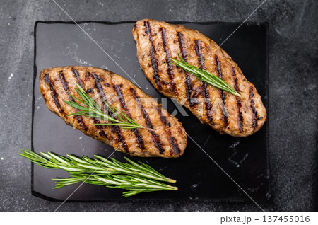Grilled lula kebabs, perfect for an authentic Middle Eastern feast. black background. top view Grilled lula kebabs, perfect for an authentic Middle Eastern feast. black background. top view 137455016