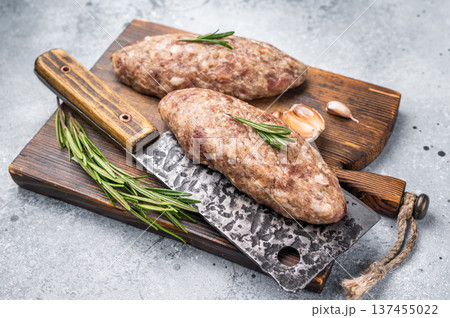 Succulent raw kofta kebab pieces marinated in spices, ideal for grilling enthusiasts looking to elevate their barbecue game. grey background. top view 137455022
