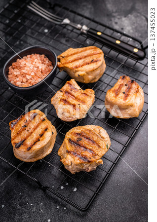 BBQ grilled pork medallions steaks, tenderloin fillet meat. black background. top view BBQ grilled pork medallions steaks, tenderloin fillet meat. black background. top view 137455023