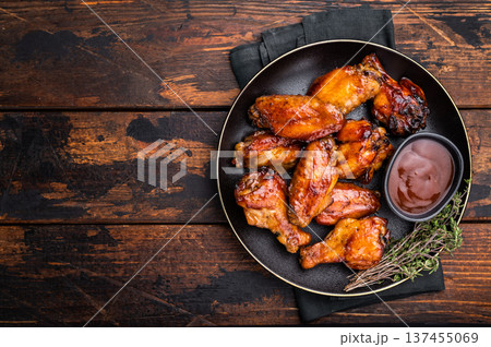 Deliciously sticky teriyakis sauce chicken wings, bursting with flavor, perfect for sharing at festive occasions or family dinners. wooden background. top view 137455069