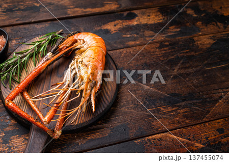 Juicy grilled giant river prawn shrimp served with rosemary, a mouthwatering dish for your next barbecue. wooden background. top view Juicy grilled giant river prawn shrimp served with rosemary, a mouthwatering dish for your next barbecue. wooden background. top view 137455074
