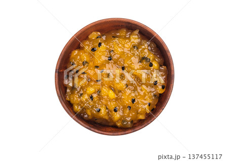 Mango and passion fruit jam with crunchy seeds in wooden bowl, sweet tropical fruit blend isolated on white 137455117