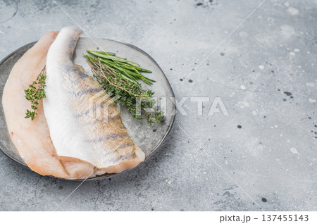 Fresh zander fillet, also called walleye or pike perch, raw white freshwater fish prepared with thyme and rosemary. 137455143