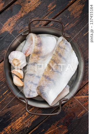 Raw pike perch fillets with skin on rustic wooden background, fresh lean freshwater white fish with garlic, ready for cooking. Raw pike perch fillets with skin on rustic wooden background, fresh lean freshwater white fish with garlic, ready for cooking. 137455164