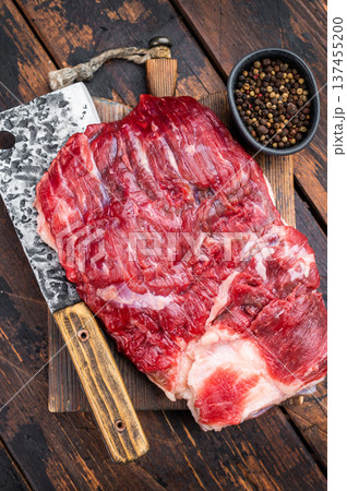 Raw beef brisket with cleaver on rustic wooden table, top view with copy space, fresh meat cut for barbecue and slow smoking Raw beef brisket with cleaver on rustic wooden table, top view with copy space, fresh meat cut for barbecue and slow smoking 137455200