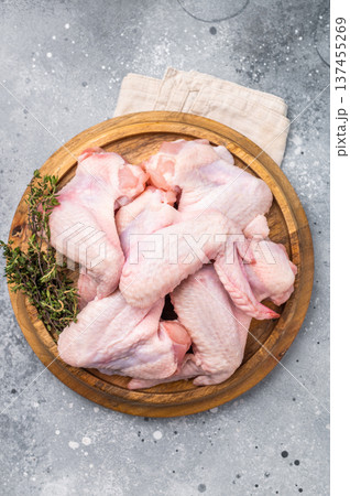 Fresh raw chicken wings, perfect for marinating and grilling, ready to become the star of your next barbecue. grey background. top view 137455269