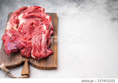 Fresh raw beef neck meat, perfect for slow cooking and creating rich, flavorful stews and hearty dishes. white background. top view Fresh raw beef neck meat, perfect for slow cooking and creating rich, flavorful stews and hearty dishes. white background. top view 137455283