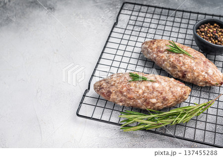 Close up of raw adana kebab meat skewers, seasoned to perfection, showcasing vibrant colors and tantalizing textures. white background. top view Close up of raw adana kebab meat skewers, seasoned to perfection, showcasing vibrant colors and tantalizing textures. white background. top view 137455288