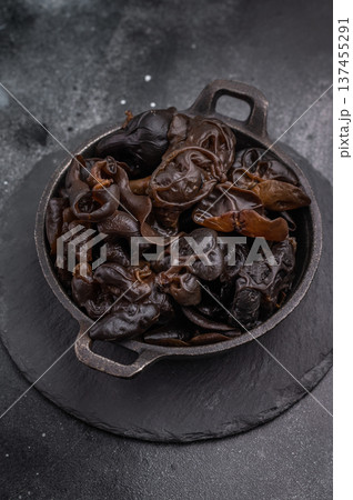 A bowl of fresh wood ear mushrooms, perfect for health conscious cooks seeking nutritious and flavorful ingredient. black background. top view A bowl of fresh wood ear mushrooms, perfect for health conscious cooks seeking nutritious and flavorful ingredient. black background. top view 137455291