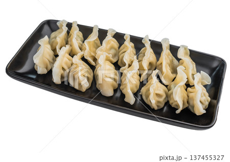 Soft pleated Asian dumplings with savory filling served on dark plate overhead shot great for stock images and menu design. Soft pleated Asian dumplings with savory filling served on dark plate overhead shot great for stock images and menu design. 137455327