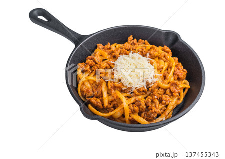 Delicious pasta bolognese with savory meat ragu and parmesan shreds presented in a cast iron skillet on minimalist white background. 137455343