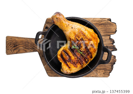 Grilled chicken leg or quarter in a skillet, roasted poultry meat isolated on white background. Grilled chicken leg or quarter in a skillet, roasted poultry meat isolated on white background. 137455399