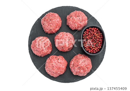 Fresh raw meatballs Frikadelwith pepper on black stone plate over light background ideal for cooking, protein and food preparation themes. Fresh raw meatballs Frikadelwith pepper on black stone plate over light background ideal for cooking, protein and food preparation themes. 137455409