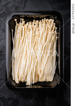 Top view of raw Enokitake (Golden Needle) mushrooms. Healthy Asian food ingredient. Perfect for food blogs and gourmet cooking concepts. Top view of raw Enokitake (Golden Needle) mushrooms. Healthy Asian food ingredient. Perfect for food blogs and gourmet cooking concepts. 137455452