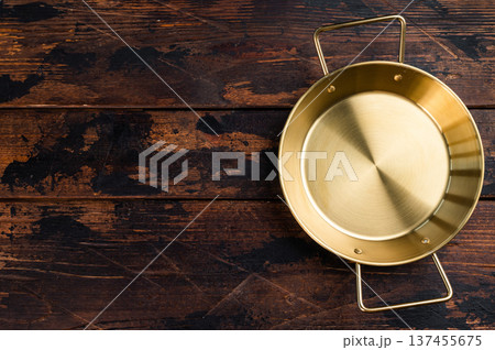 Golden brass style frying pan with two handles on rustic wooden table, top view kitchen cookware with copy space Golden brass style frying pan with two handles on rustic wooden table, top view kitchen cookware with copy space 137455675