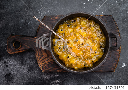 Granadilla mango fruit coulis in cast iron pan, vibrant tropical dessert topping with rich color and shine 137455701