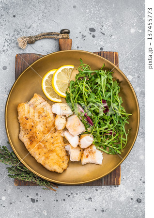 Crispy fried redfish fillet with green salad and citrus. Balanced seafood dinner plate. 137455773