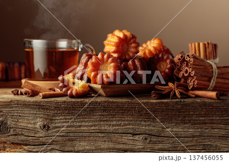 Cinnamon cakes and tea on an old wooden table. 137456055