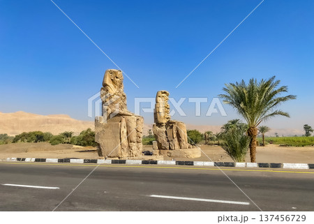 Colossi of Memnon, two massive stone statues representing the pharaoh, Luxor, Egypt Colossi of Memnon, two massive stone statues representing the pharaoh, Luxor, Egypt 137456729