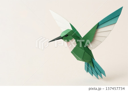 Origami bird in flight on a light background, a symbol of freedom. Space for text. 137457734