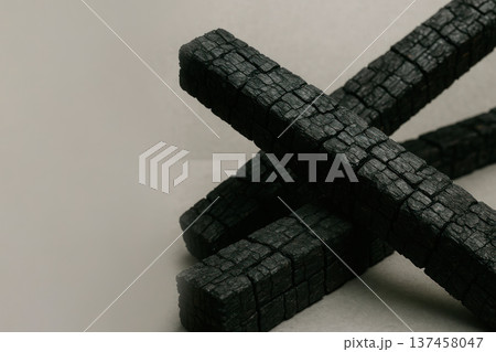 Charred wooden beams on a neutral background. Space for text. 137458047