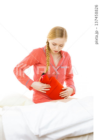 Woman feeling stomach cramps lying on bed Woman feeling stomach cramps lying on bed 137458826