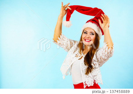 Joyful woman in christmas santa hat Joyful woman in christmas santa hat 137458889