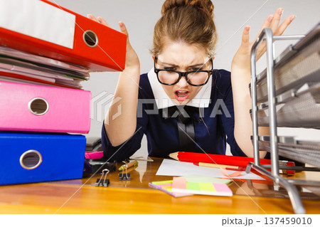 Depressed businesswoman sitting at desk Depressed businesswoman sitting at desk 137459010