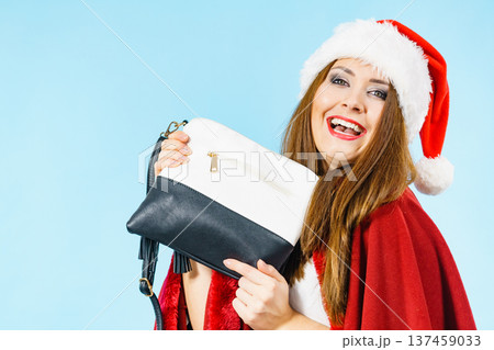 Christmas girl holding handbag present Christmas girl holding handbag present 137459033